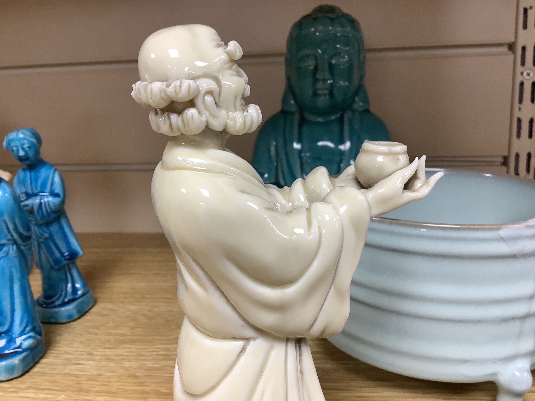 A Chinese turquoise glazed Buddha, height 21cm, a pair of figurines, a robin’s egg glazed model of a lobster, and a tripod censer